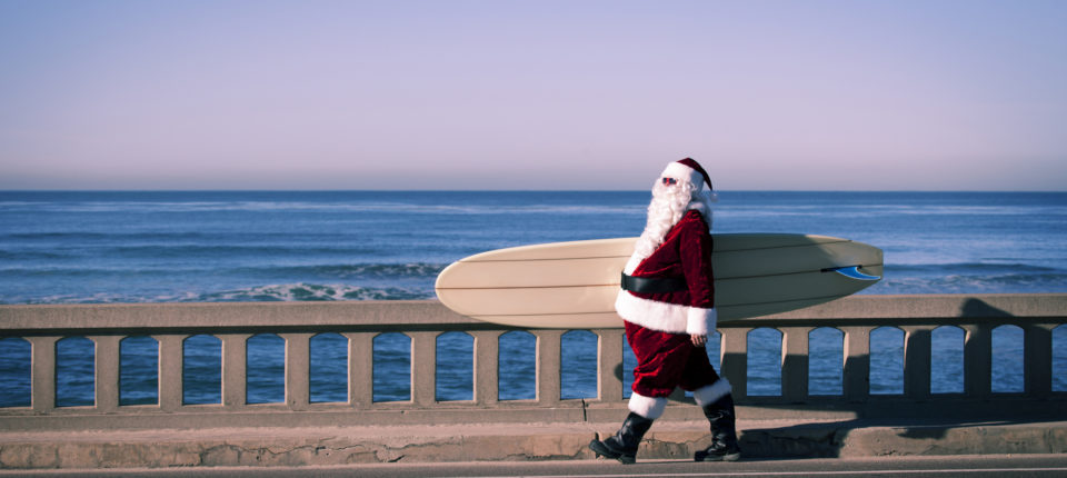 Santa Claus with a Surfboard in hand