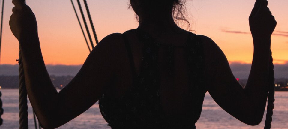 silhouette of a woman on a swing