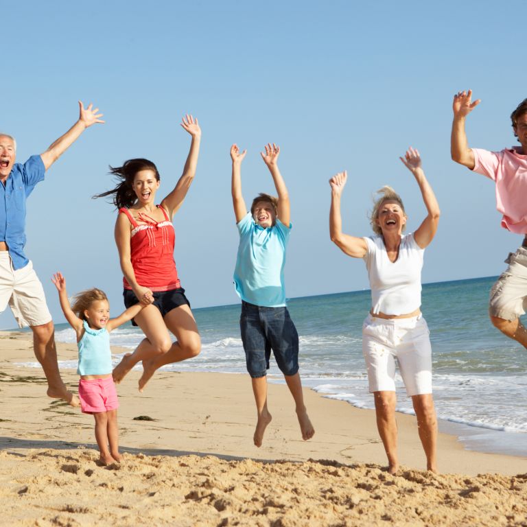 family playing on the beach