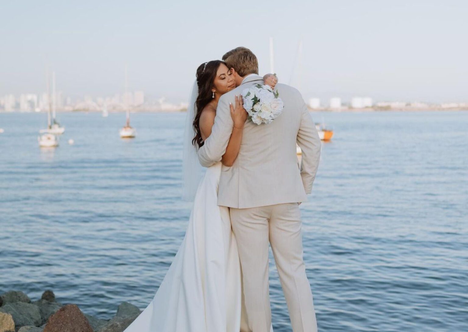 bride and groom by the water