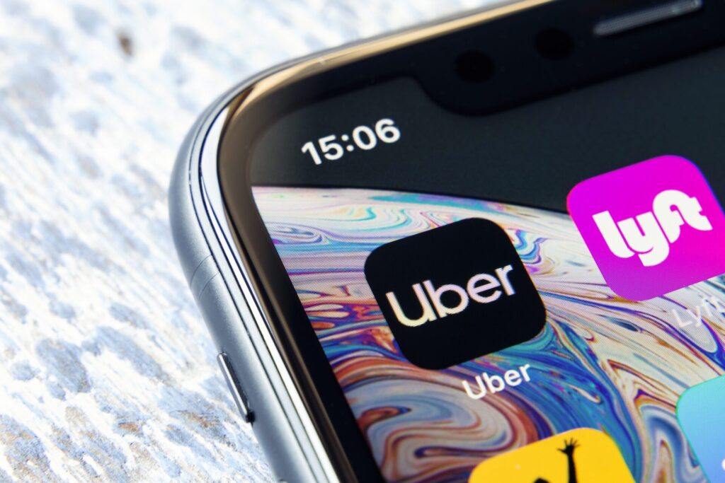 a phone with rideshare app icons