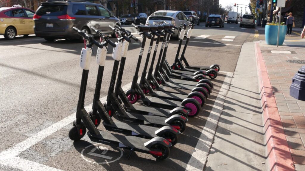 a row of rental scooters