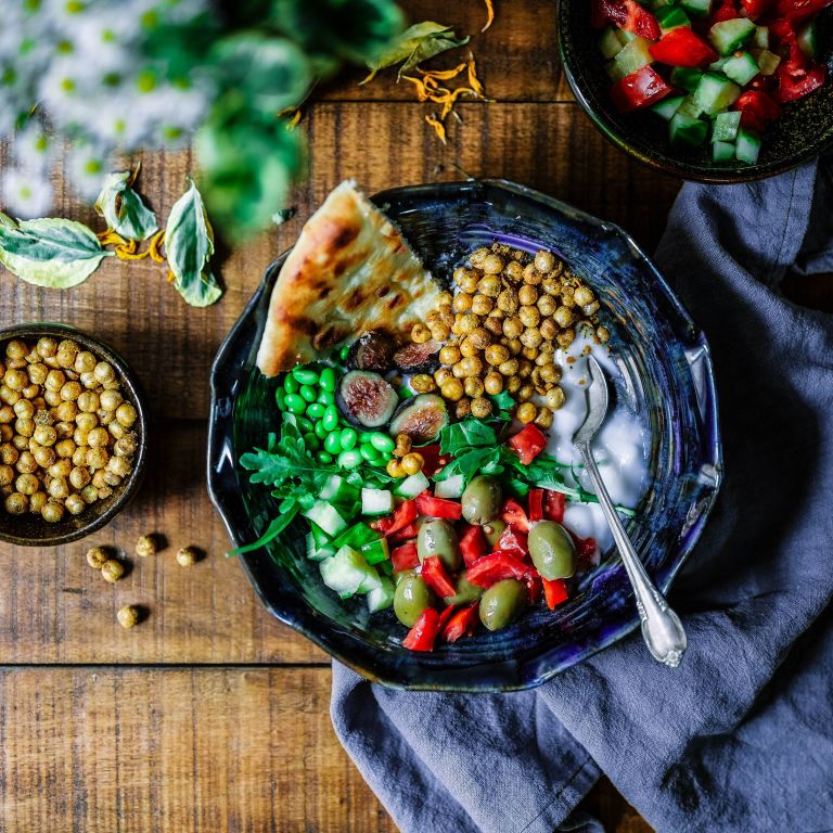 a bowl full of various colorful, vegetable dishes