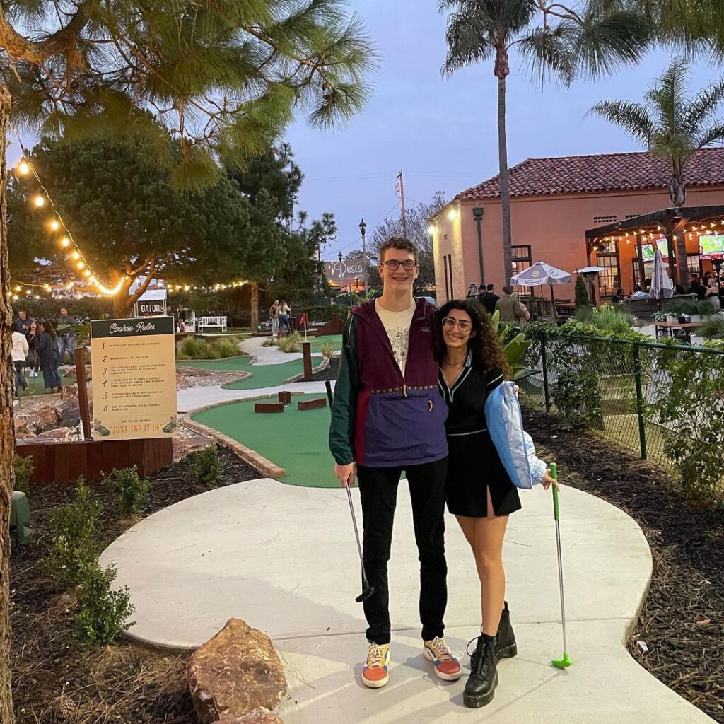 a couple playing putt putt golf