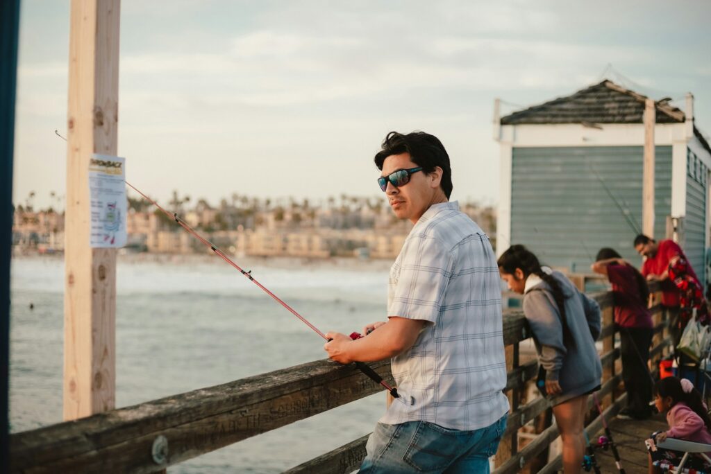 man fishing off pier