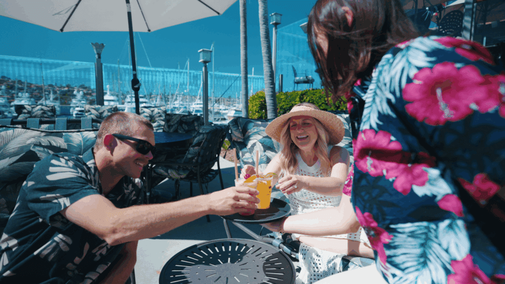 Couple being served drinks next to pool