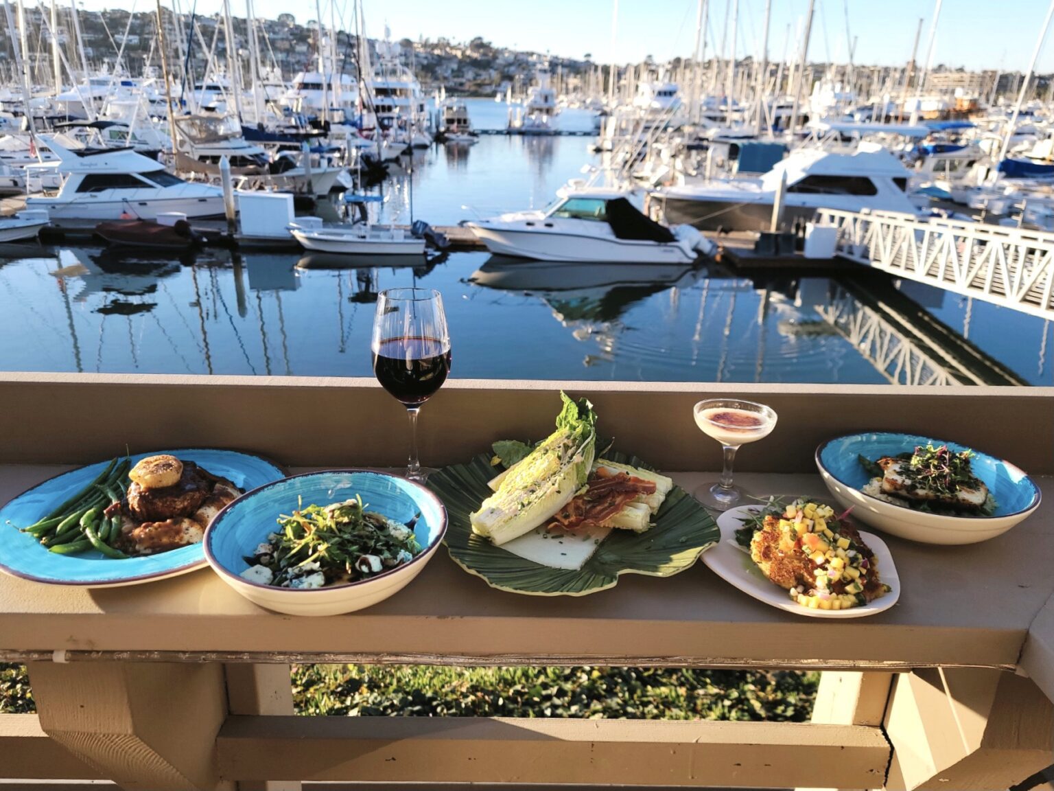 food on a table overlooking marina