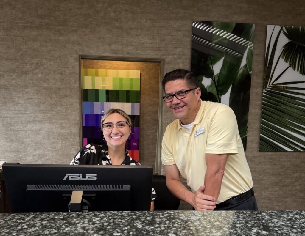 danny in front of desk at check in