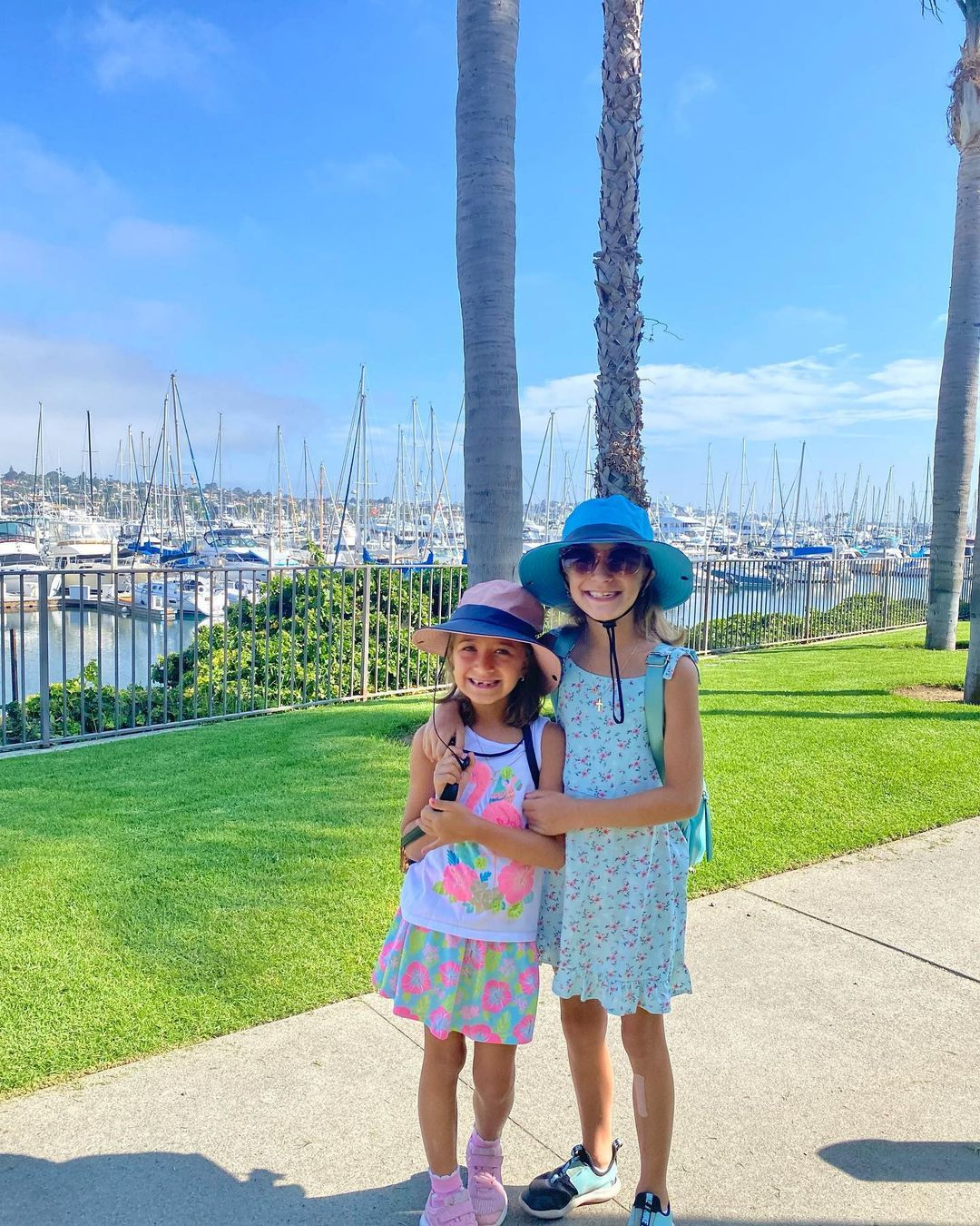 Two girls standing in front of marina
