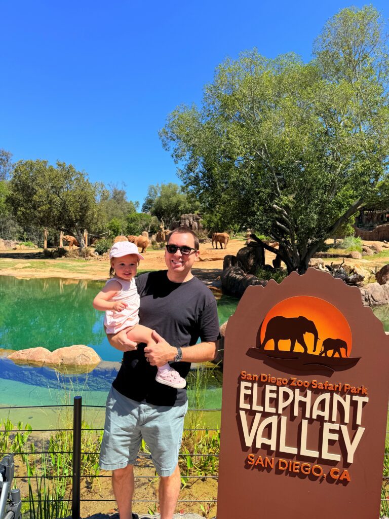 dad and girl standing in front of Elephant exhibit